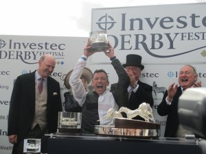Frankie Dettori celebrates after winning the Investec Derby on Golden Horn as trainer John Gosden (left) looks on.